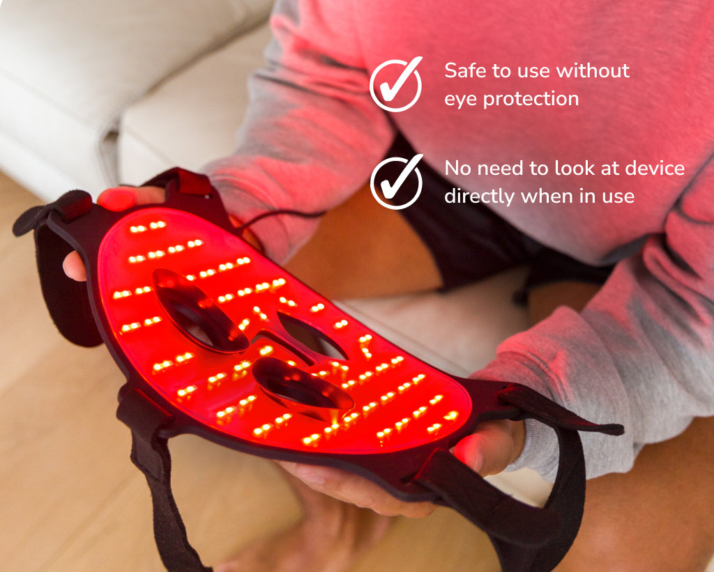 Man Holding Red Light Face Mask Showing Red Lights Inside