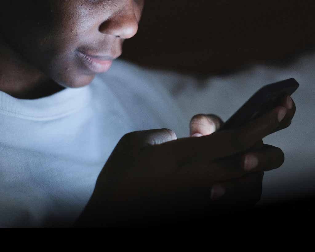 Man Using His Phone At Night